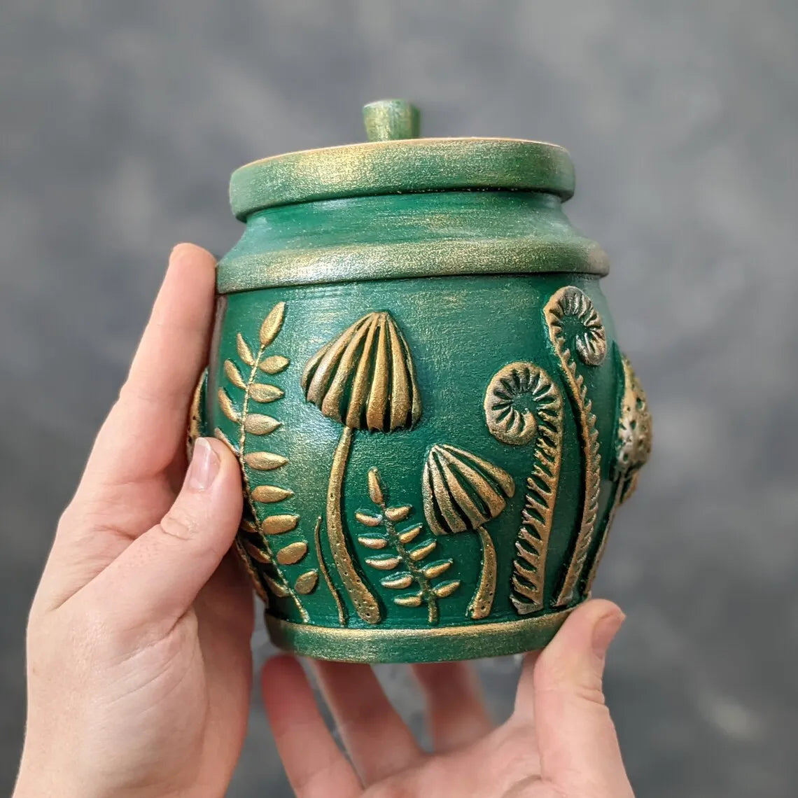 amanita mushroom emeral green pot with lid in hands