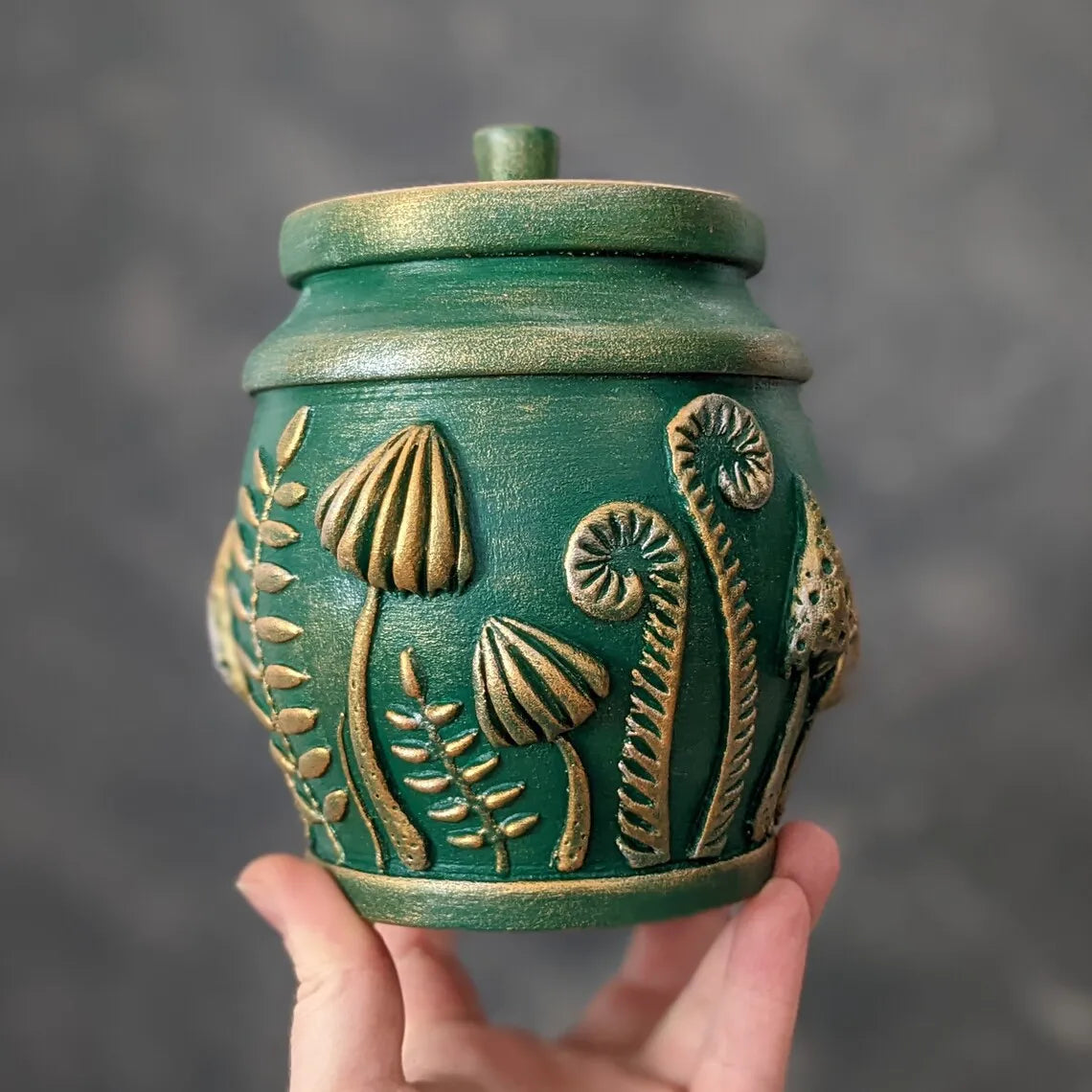 amanita mushroom emeral green pot with lid in hand