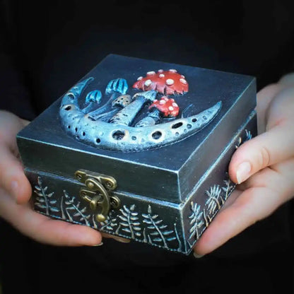 crescent moon and fly agaric wooden witches box in hands