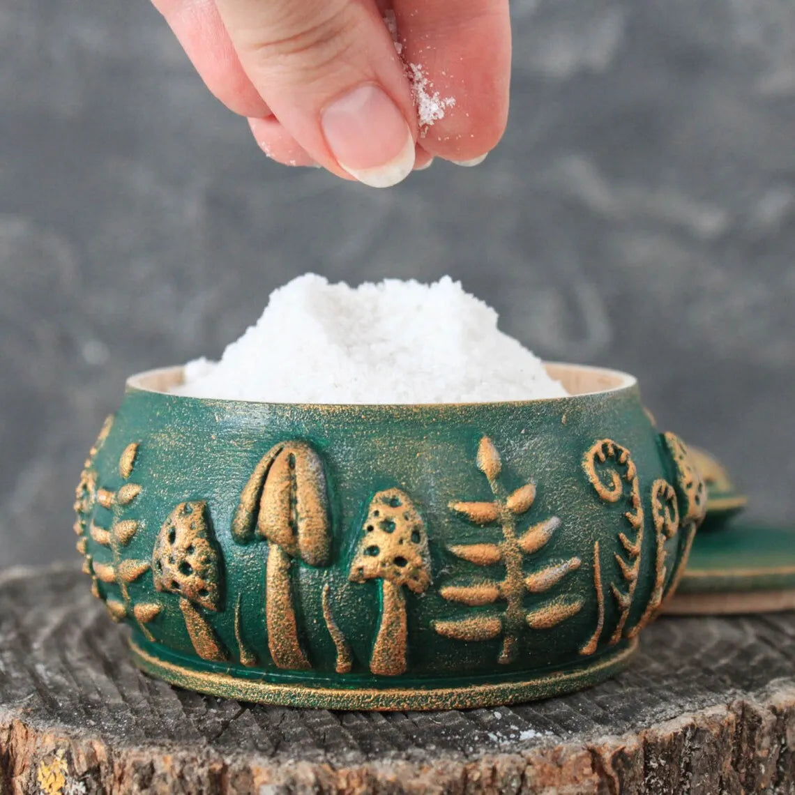 emerald forest meadow a wooden pot with a lid filled with salt