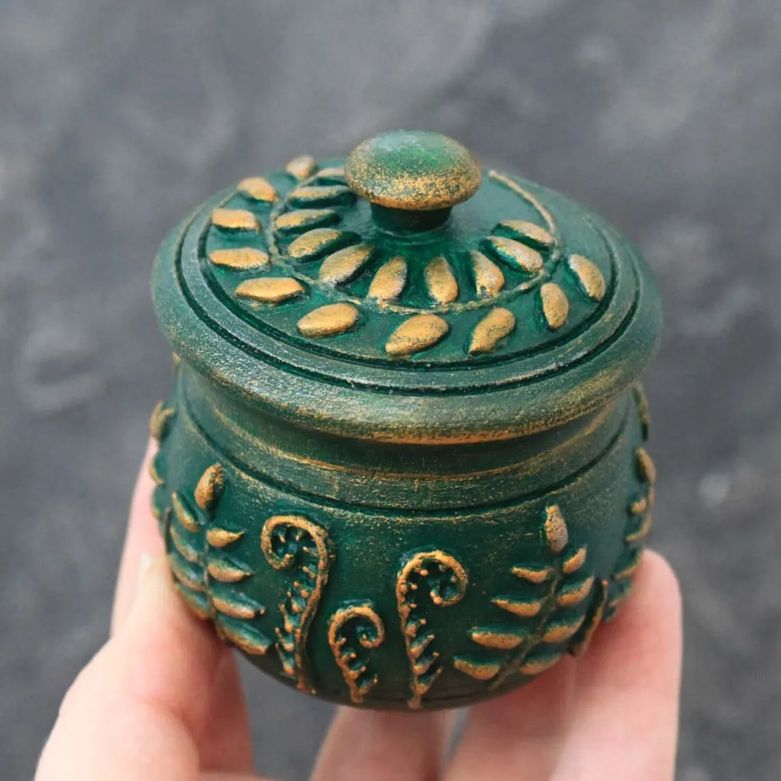 emerald magic small wooden pot with lid in hand