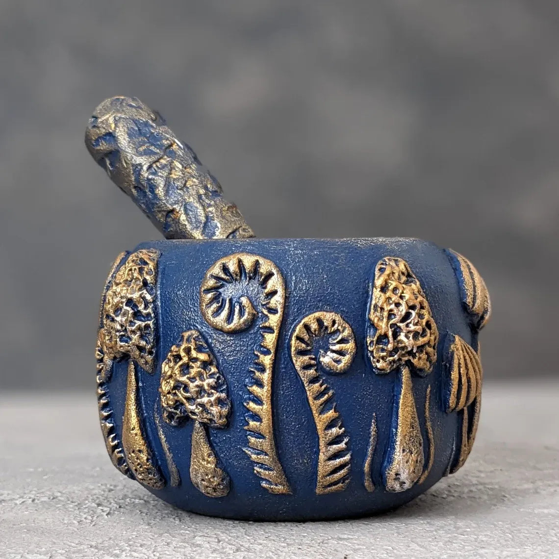 enchanted forest: blue wooden mortar and pestle pestle inside