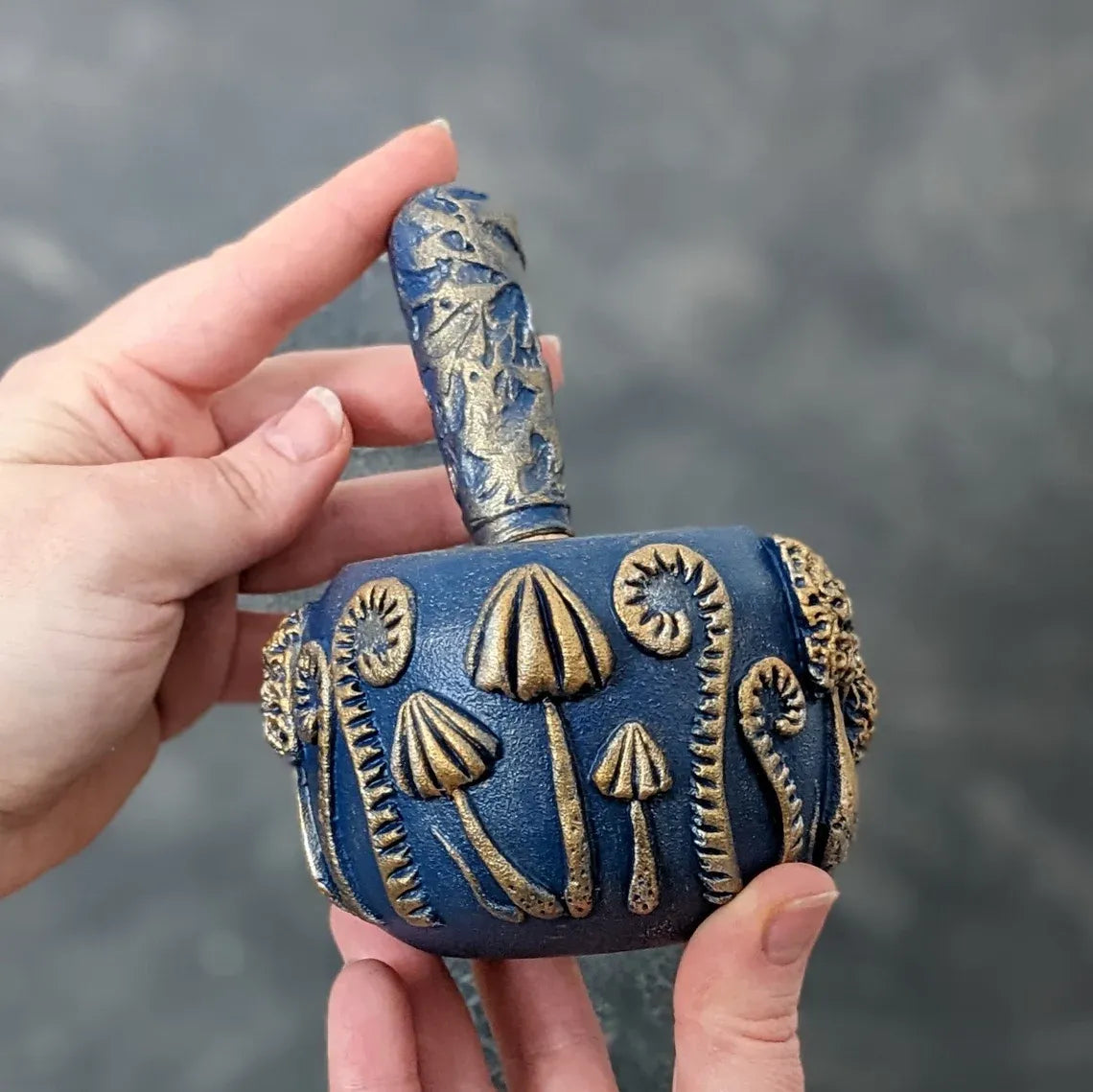 enchanted forest: blue wooden mortar and pestle in hands