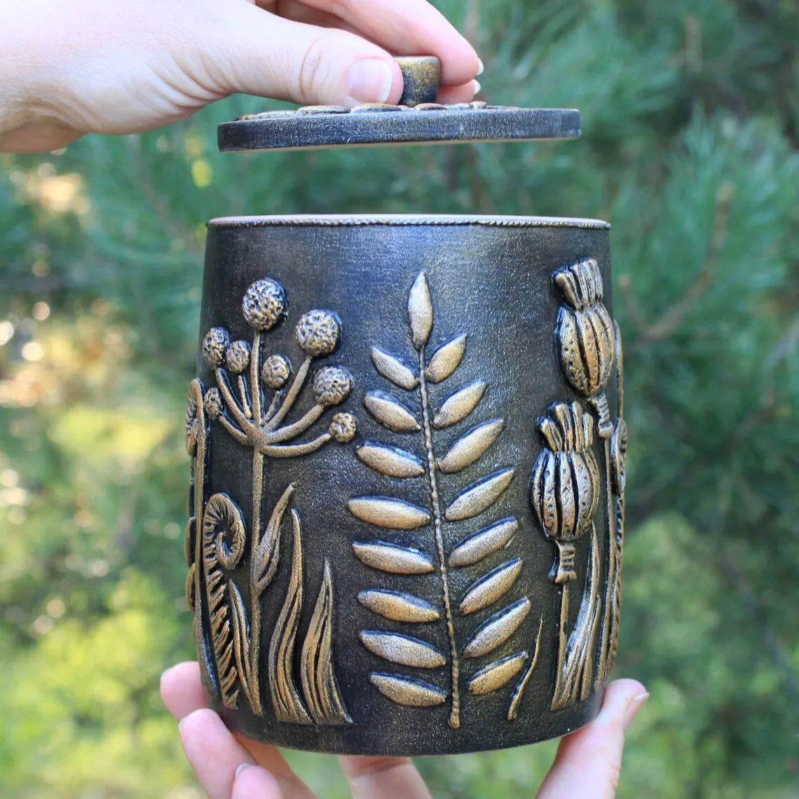 enchantment forest: wooden potter with a cracker in his hands against the backdrop of nature