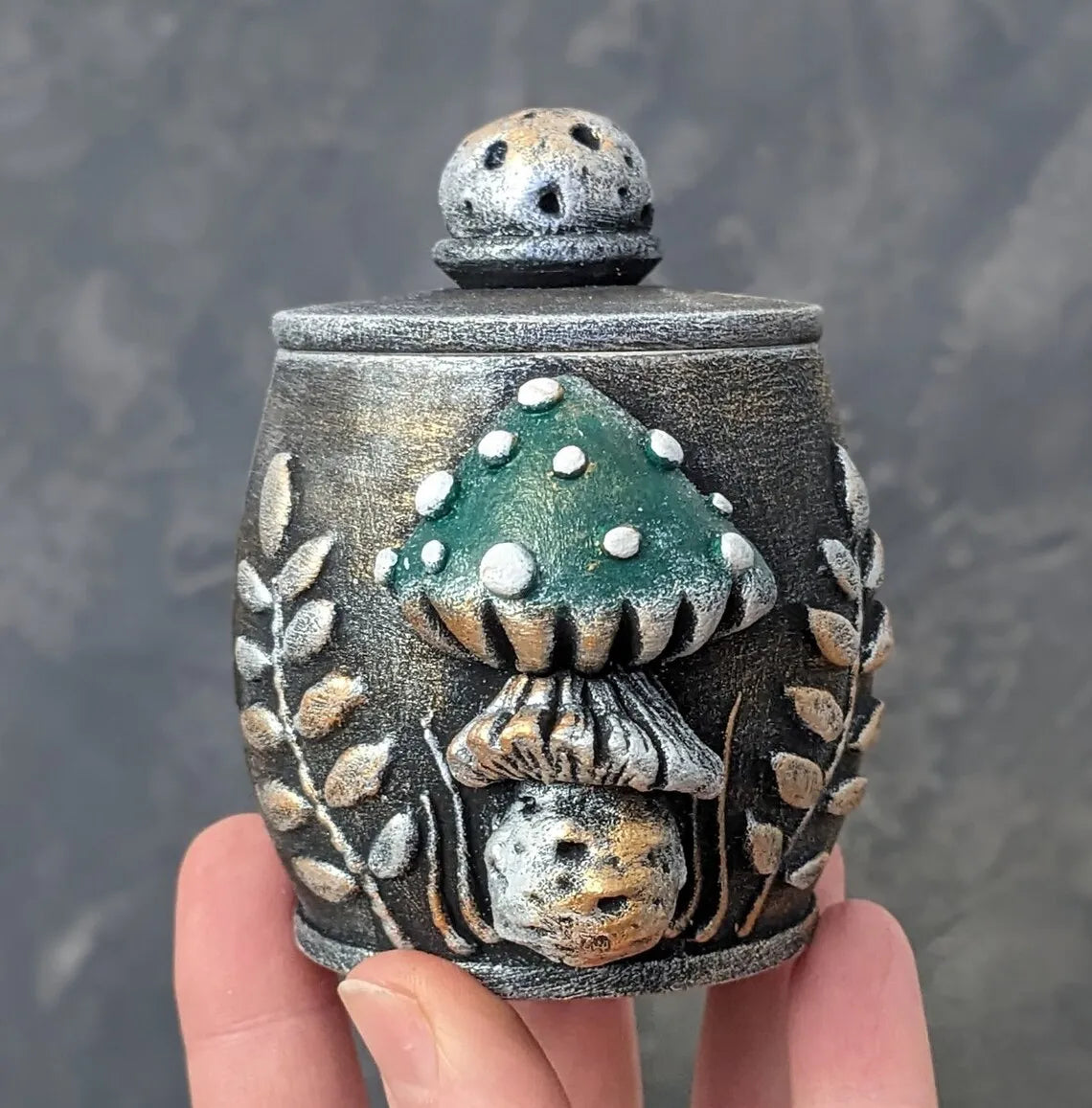 fly agaric mushroom wooden pot with lid green mushroom in hand