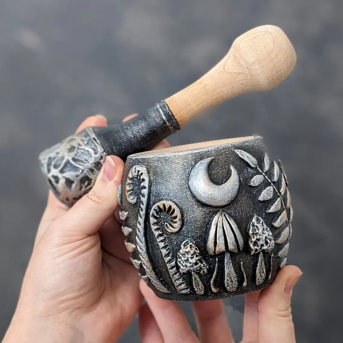 forest herbs and mushrooms under the moon wooden mortar and pestle in hands 