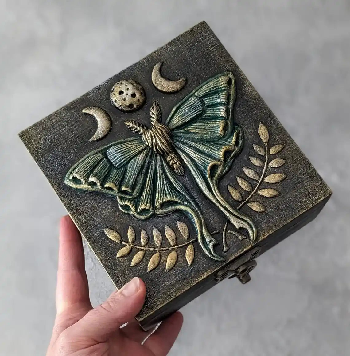 luna moth enchanting wooden witches box in the hand of green color