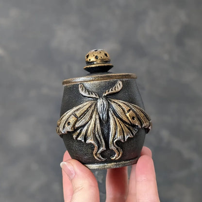 moon moth wooden pot with lid in hand