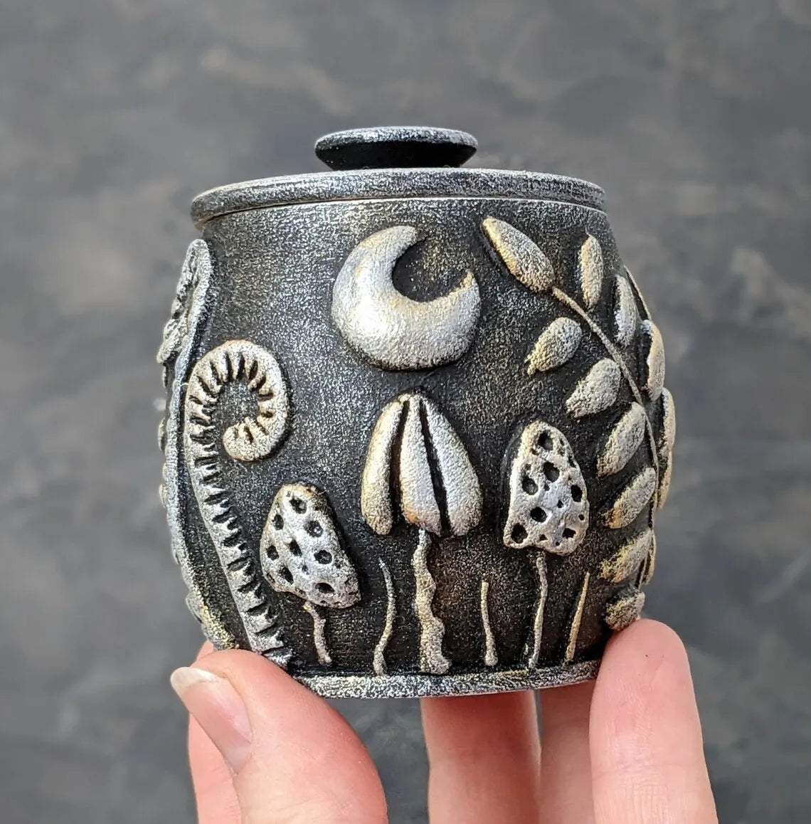 magic herbs and mushrooms under the moon wooden pot with lid silver black in hand