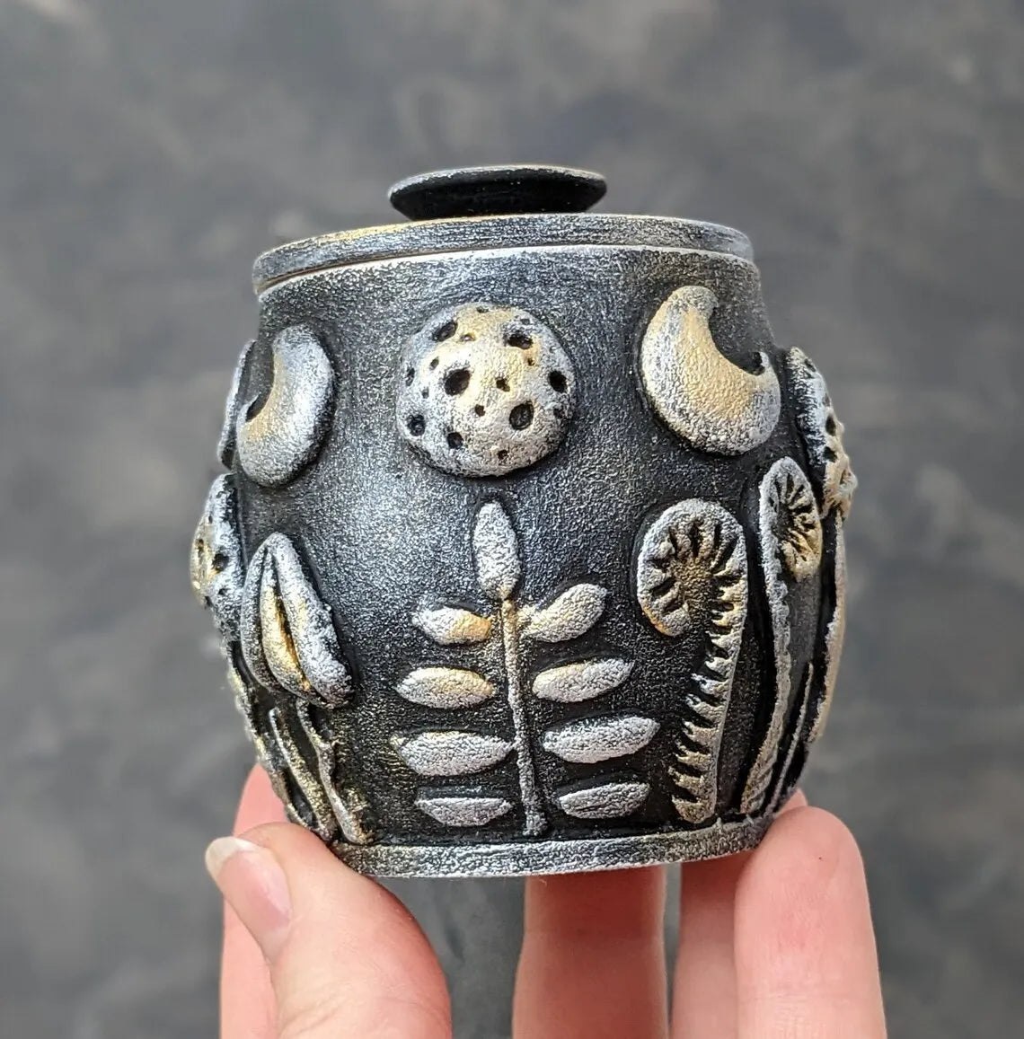 magic herbs and mushrooms under the moon wooden pot with lid in hand