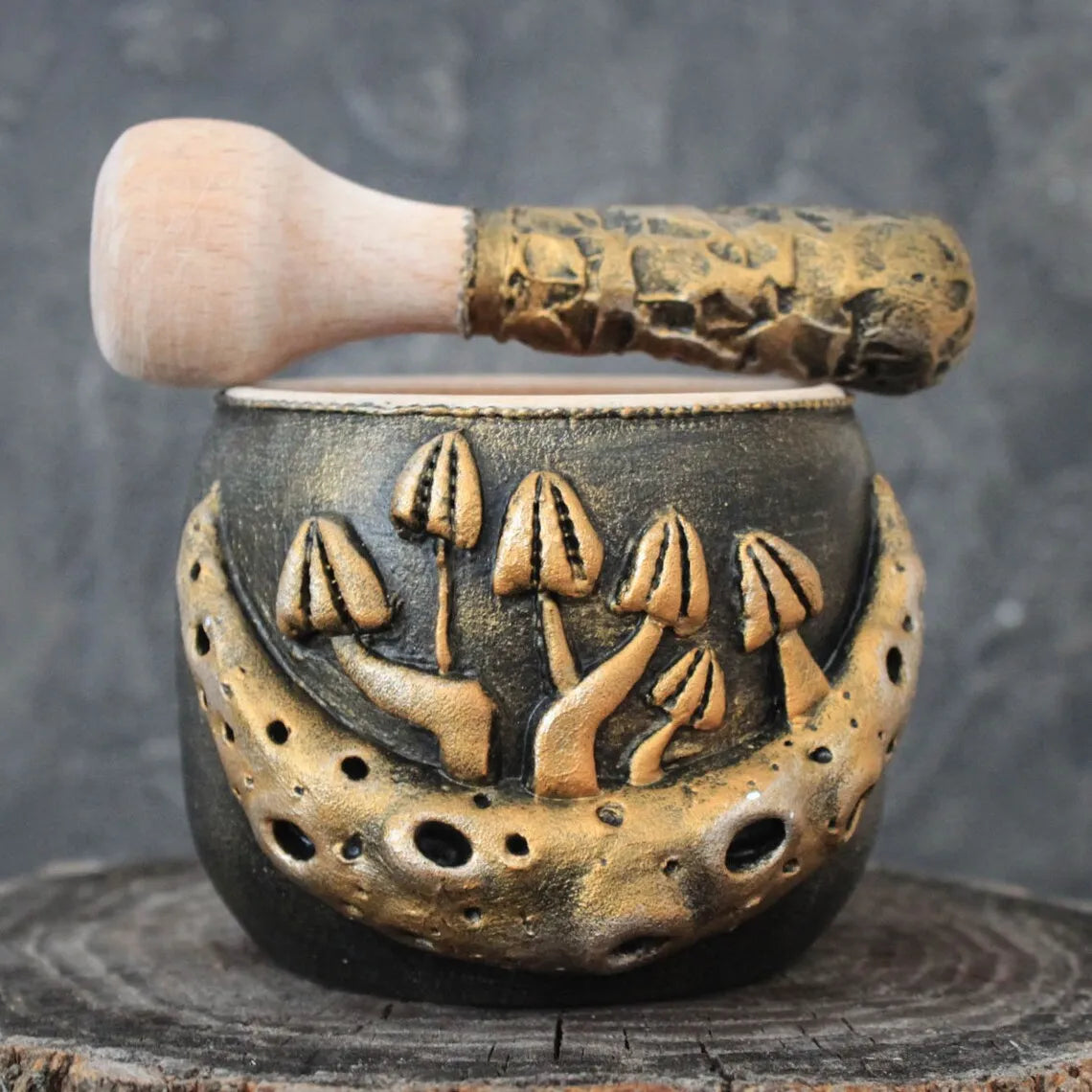 mushroom and moon wooden mortar and pestle on a dark background