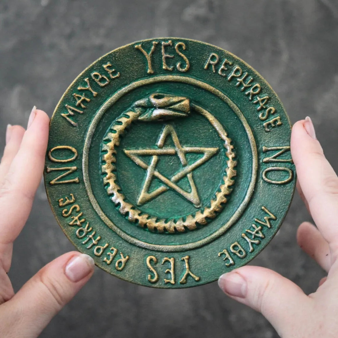 ouroboros pentagram pendulum board in hands