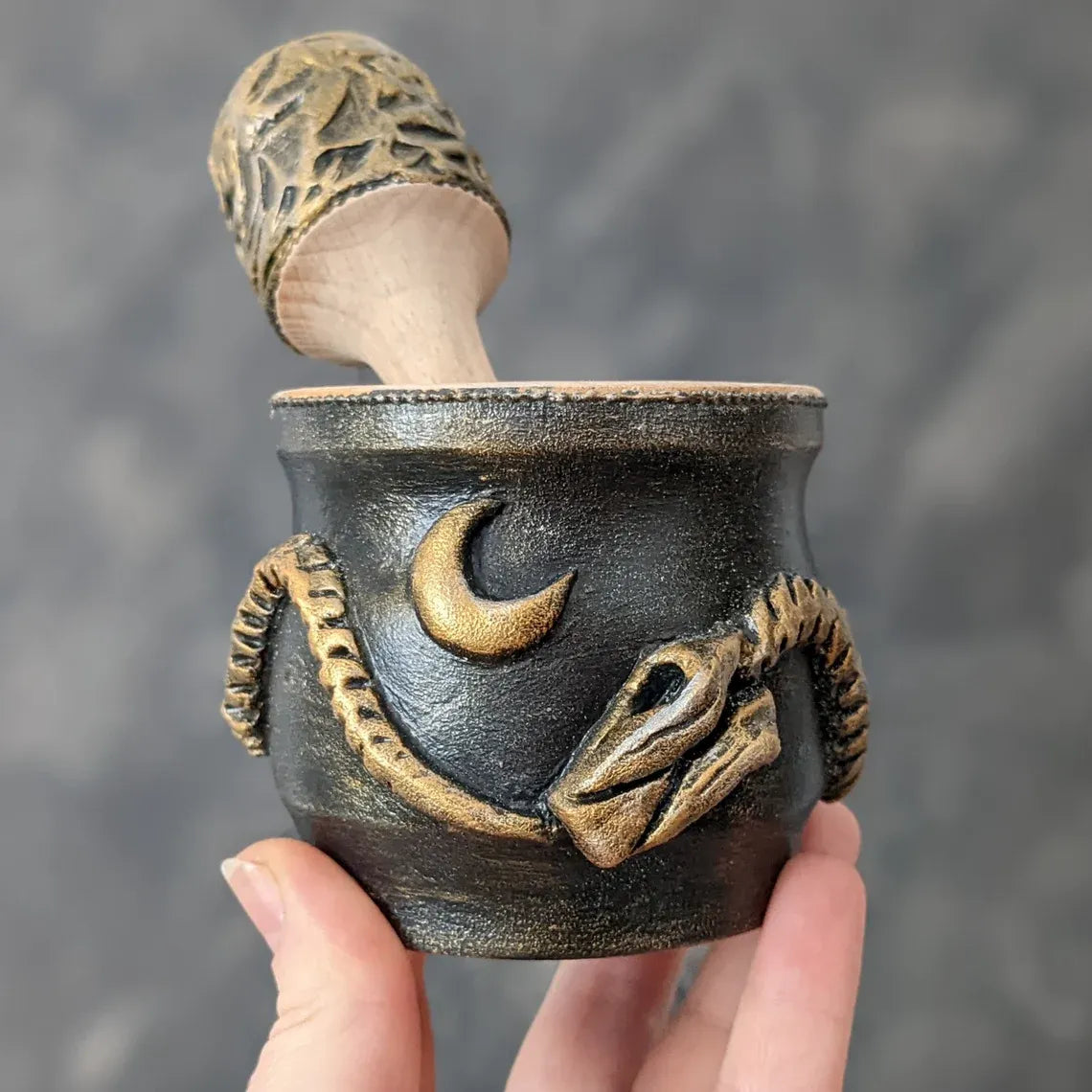 ouroboros wooden mortar and pestle in hand