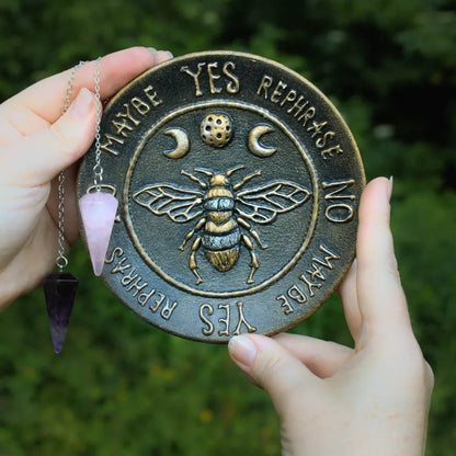 witch bee pendulum board in hands