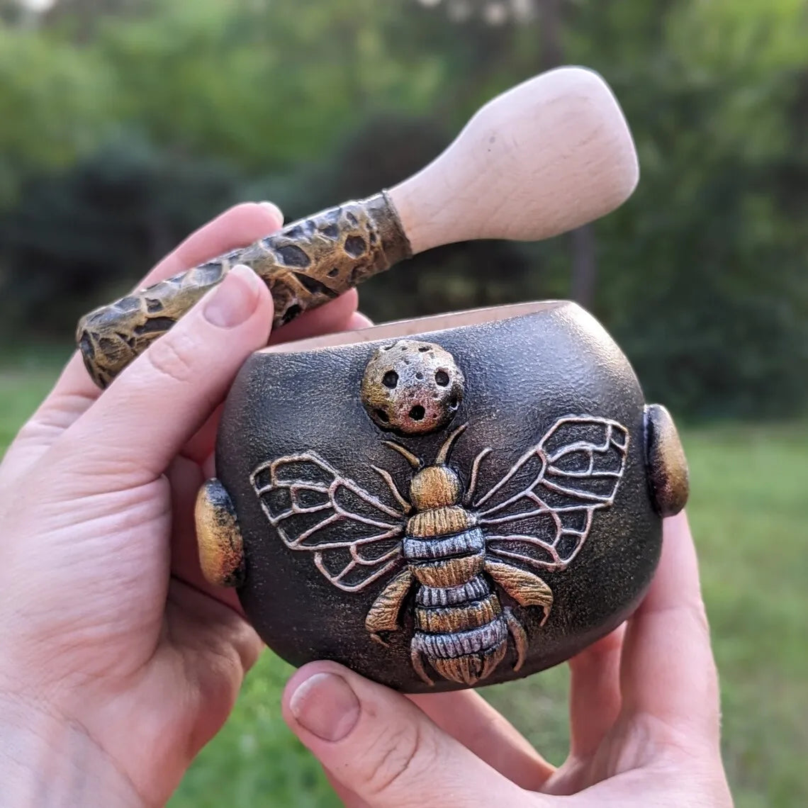 witch bee wooden mortar and pestle in hands