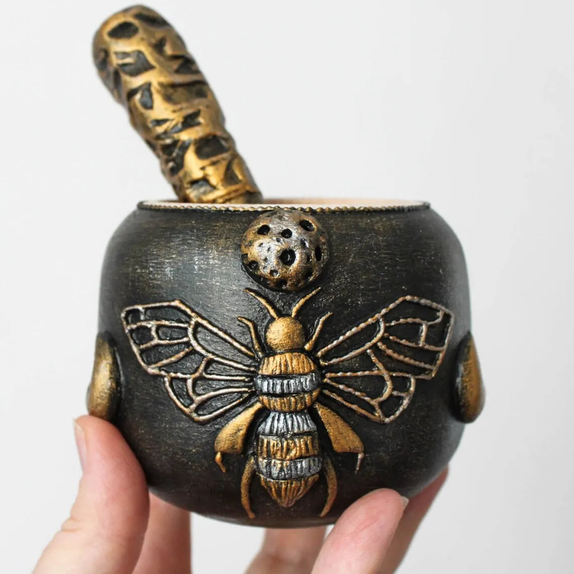 witch bee wooden mortar and pestle  in hand