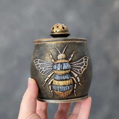 witch bee wooden pot with lid in hand