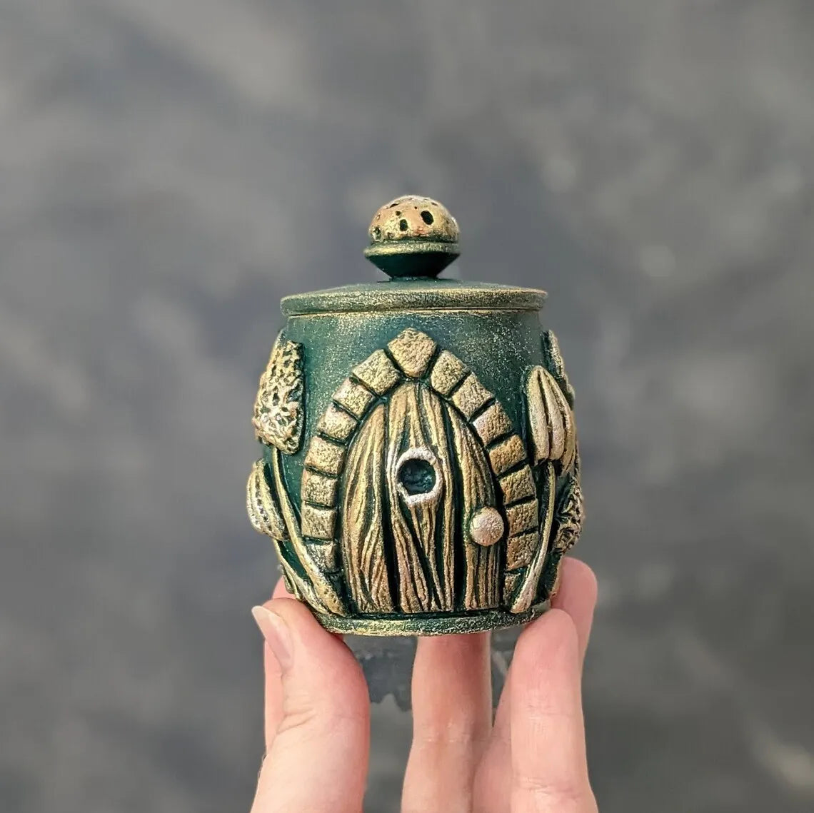 witch door emerald wooden pot with lid in hand