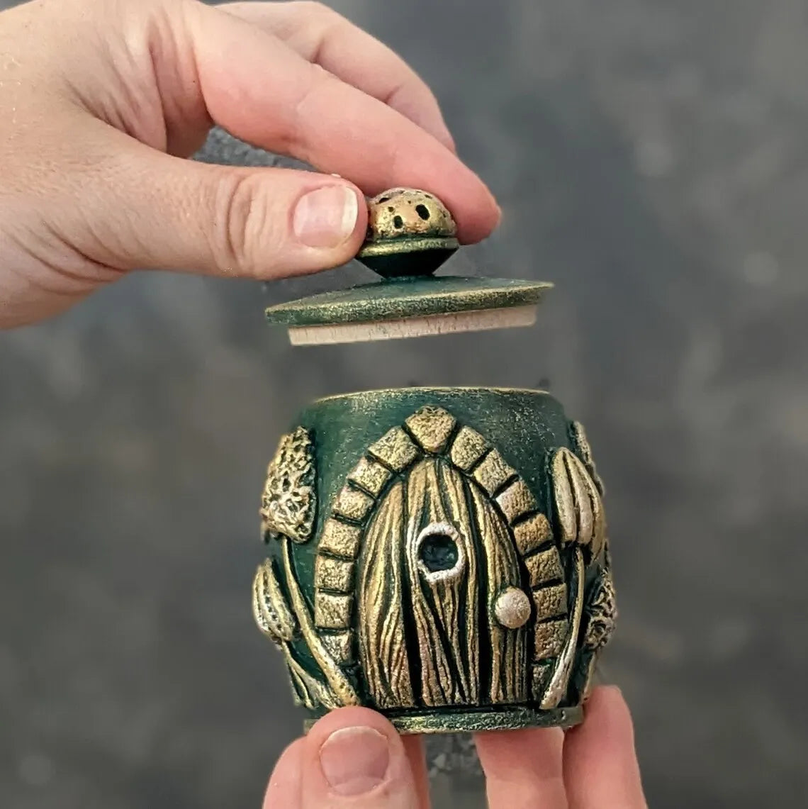 witch door emerald wooden pot with lid in hand