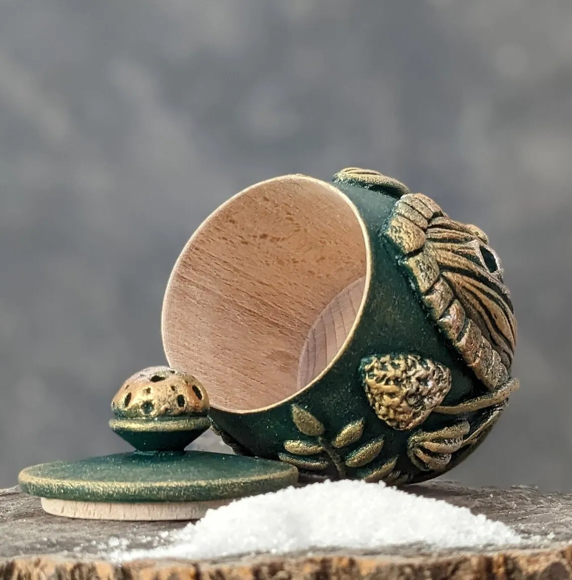 witch door an emerald wooden pot with a lid and a handful of salt