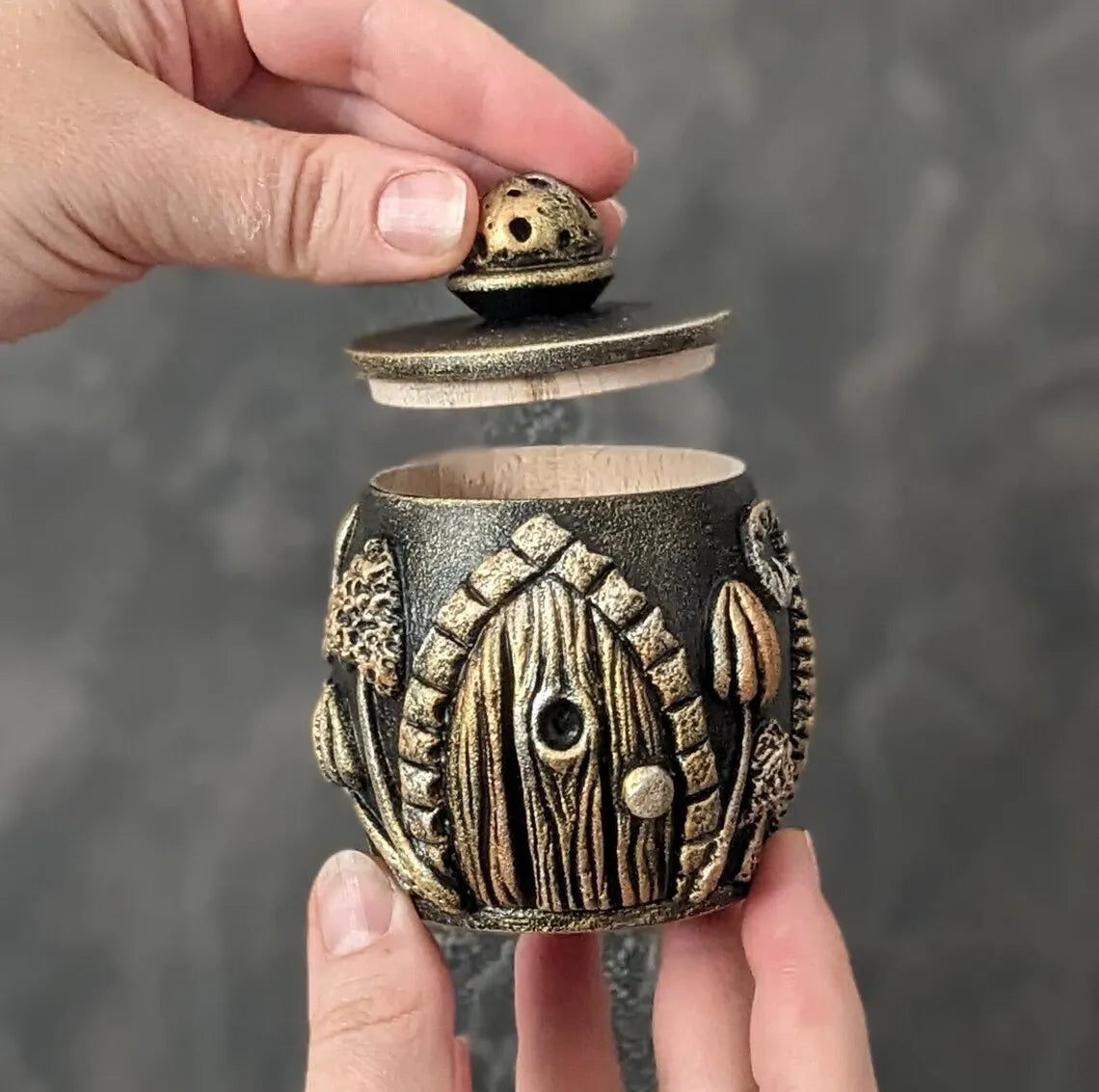 witch door golden wooden pot with lid medium size in hands